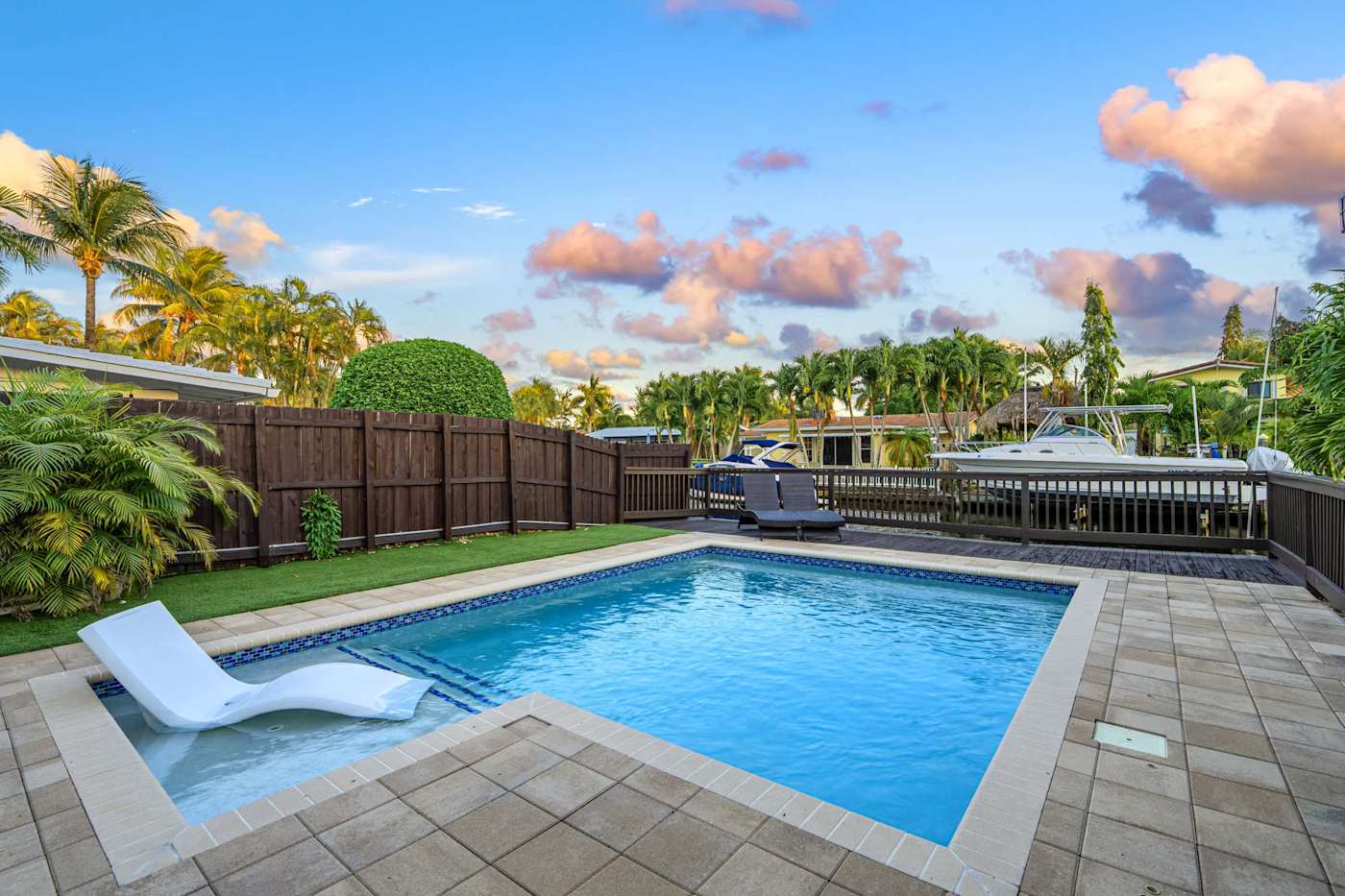 Canal House: Pool and lounger at dusk, with the dock beyond