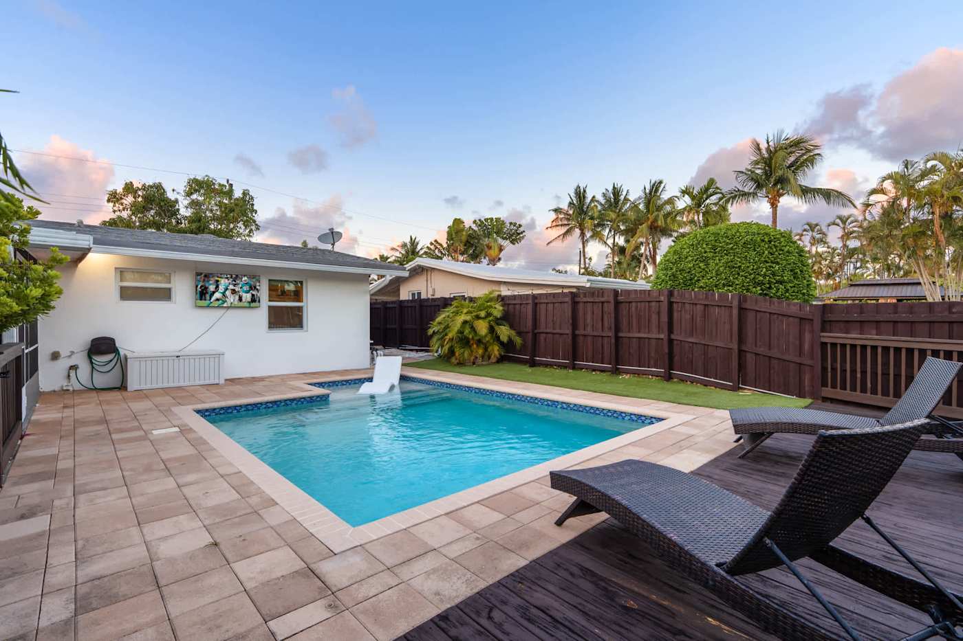 Canal House: Pool and deck in the afternoon, with loungers and lawn