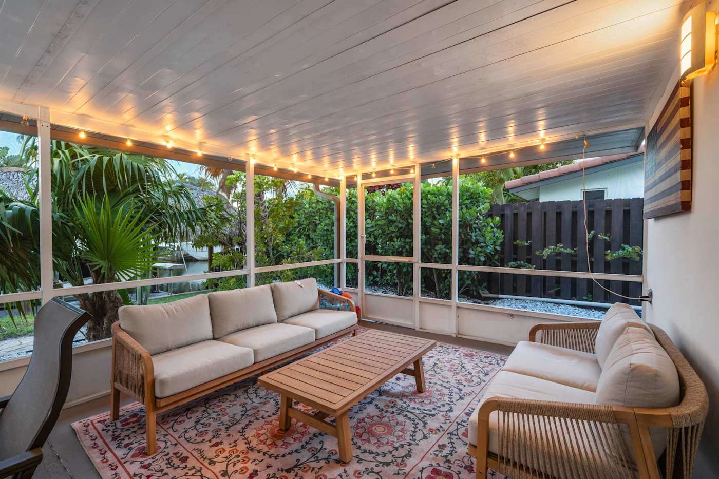 Canal House: Screened porch with sofa seating and a coffee table