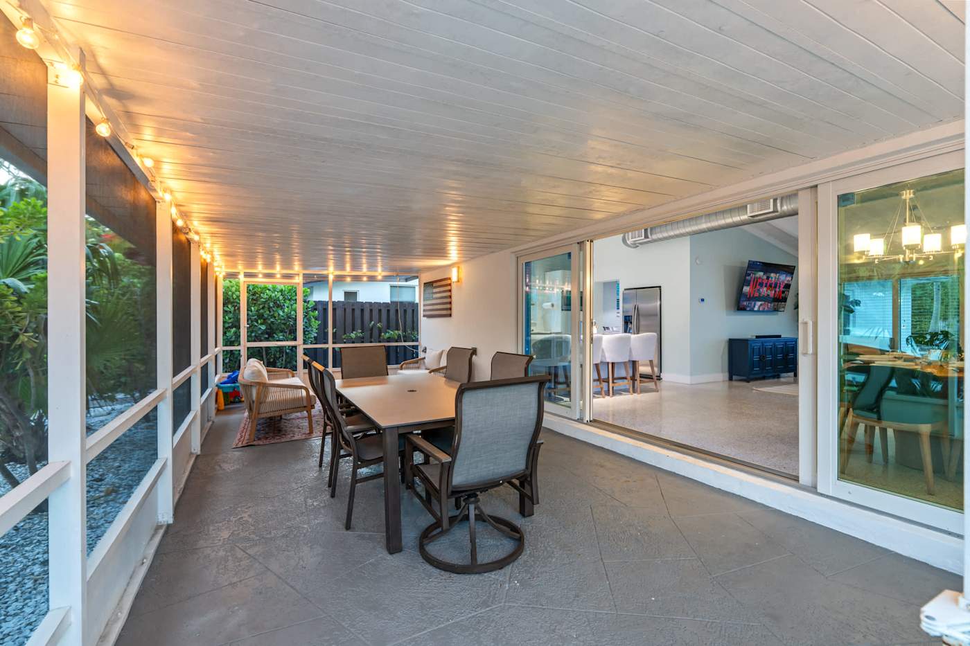 Canal House: Screened porch with dining for six, looking into the house