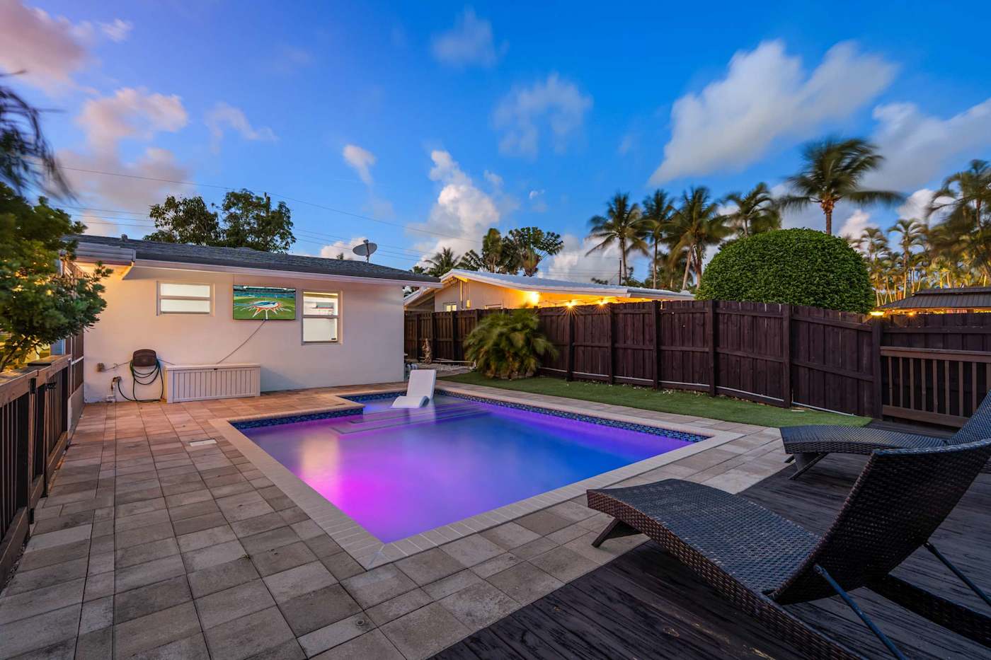 Canal House: Pool lit at dusk, seen from the deck