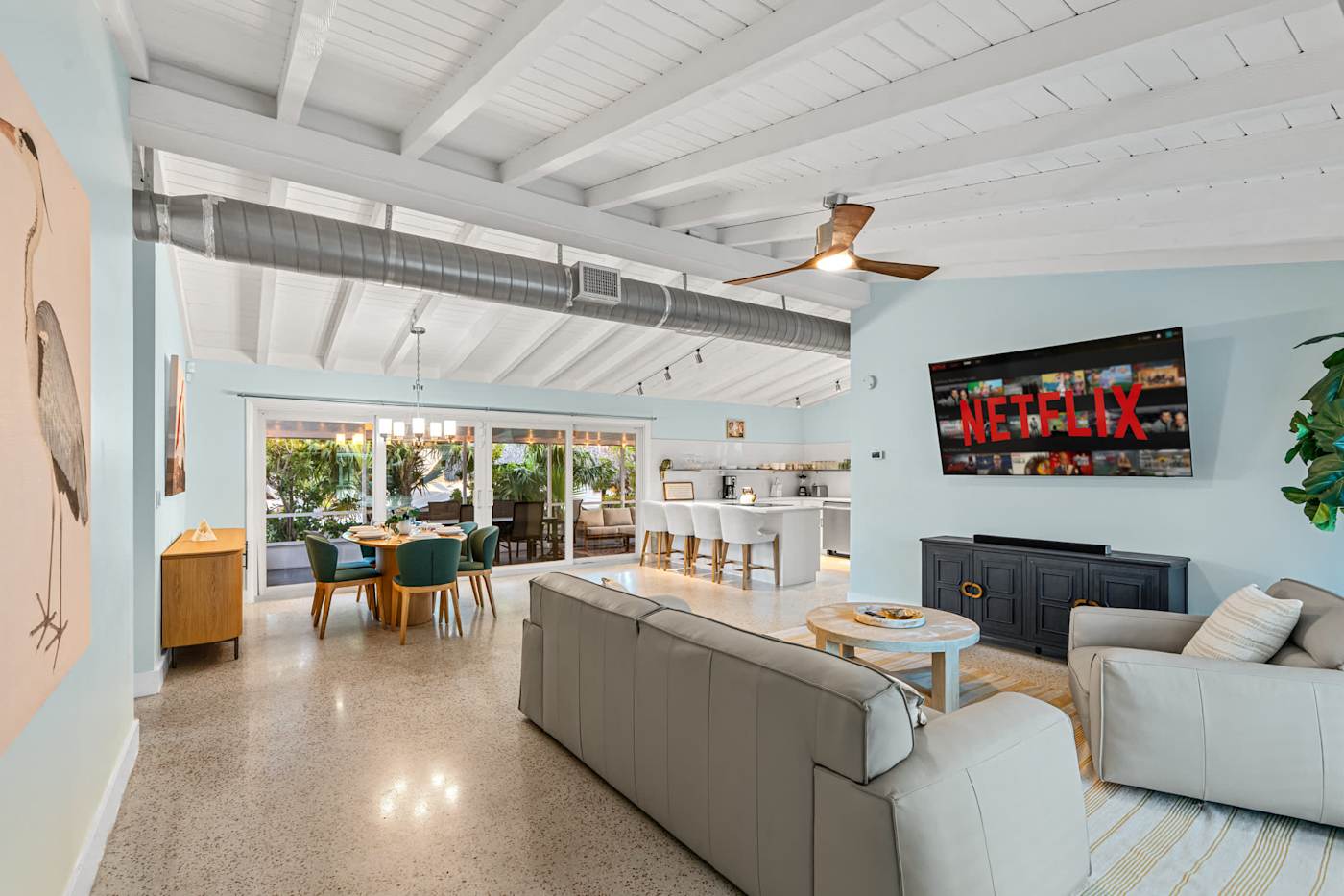 Canal House: Living room with sofas and a smart TV, dining beyond