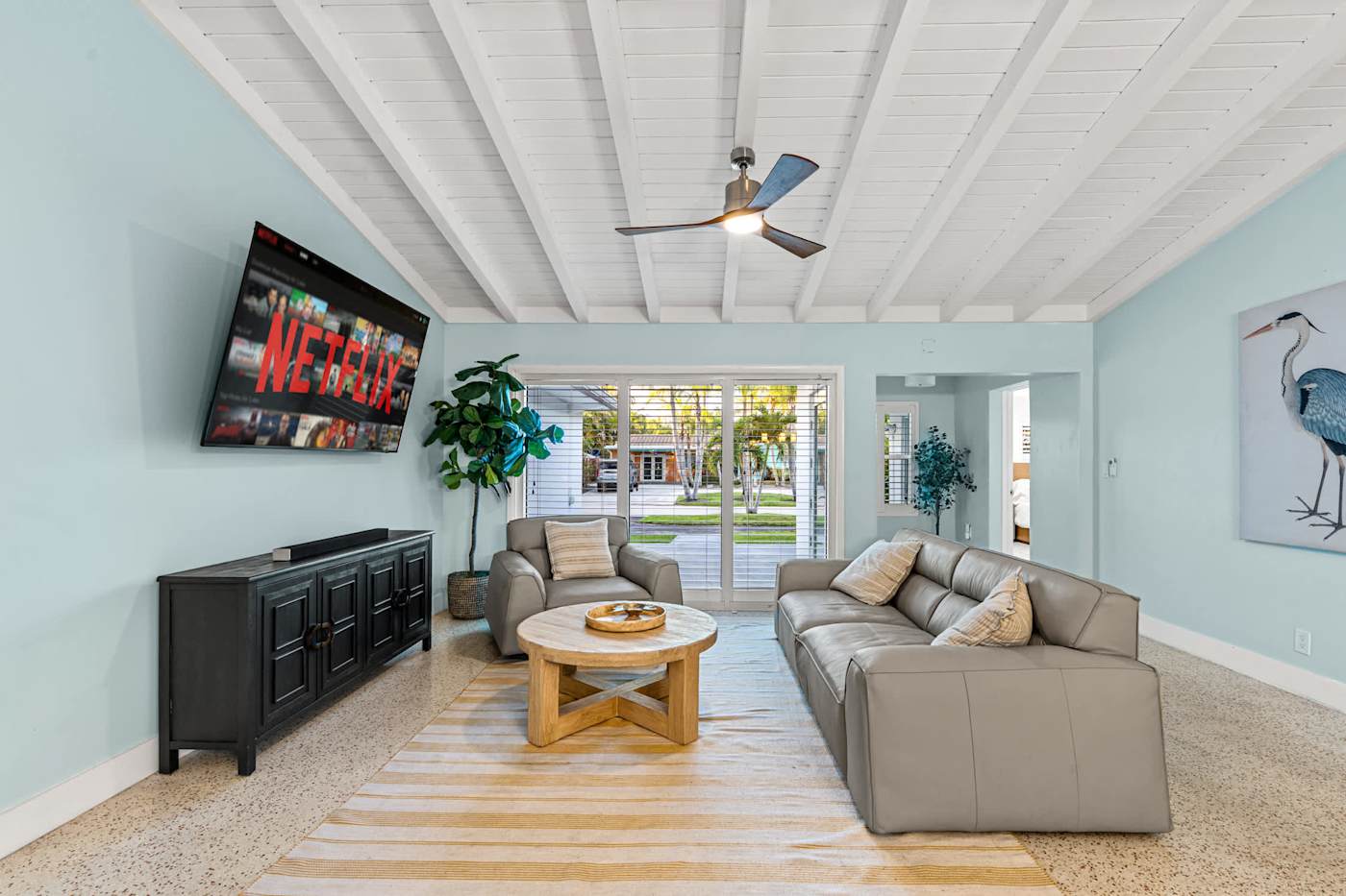 Canal House: Living room with sectional, smart TV and doors to the garden