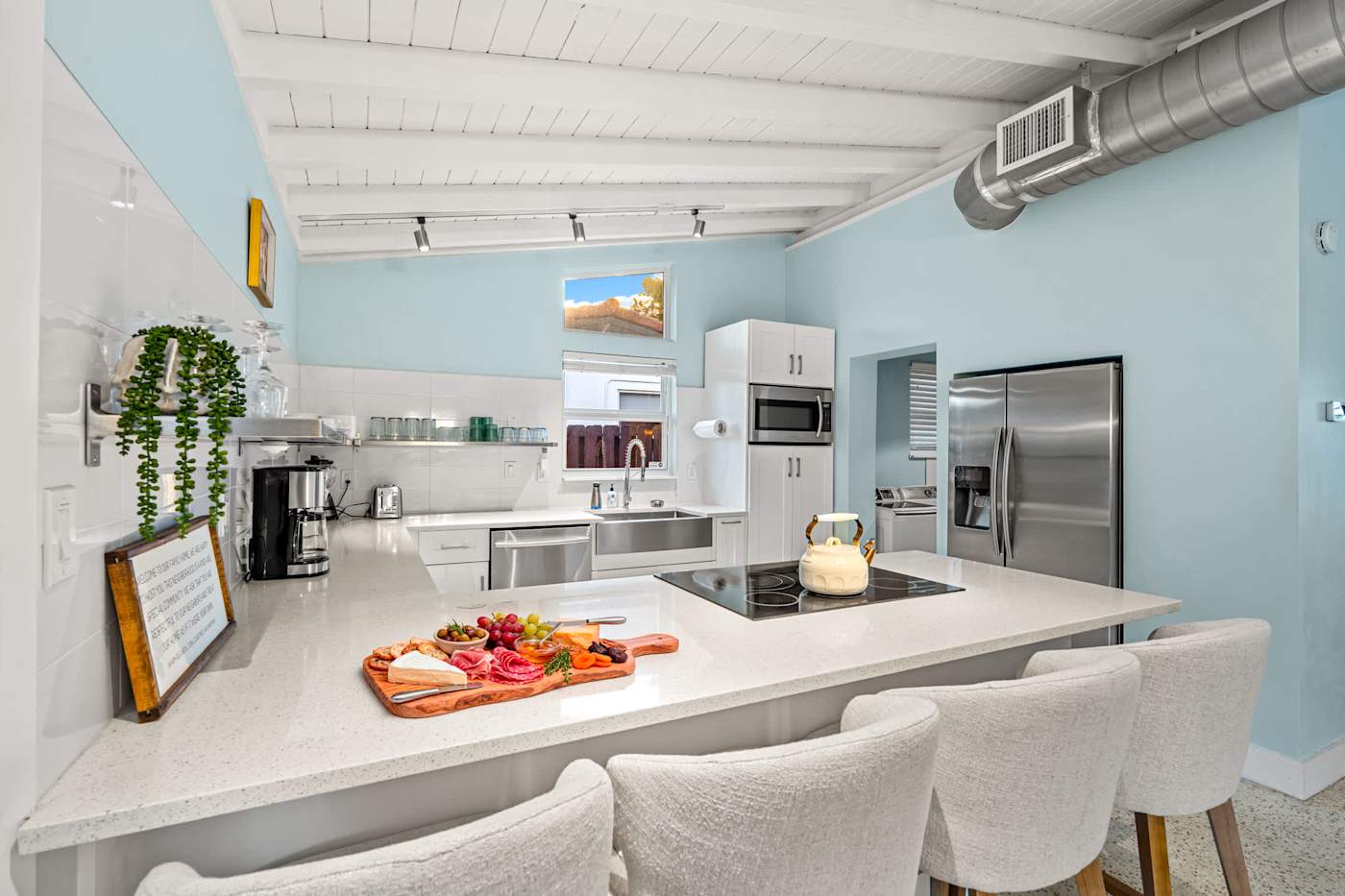 Canal House: Kitchen island with sink, dishwasher and fridge freezer