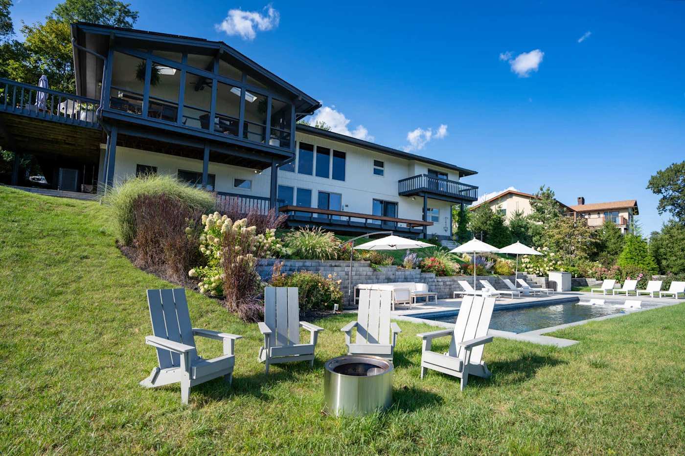 Hudson House: Adirondack chairs around the fire pit near the pool