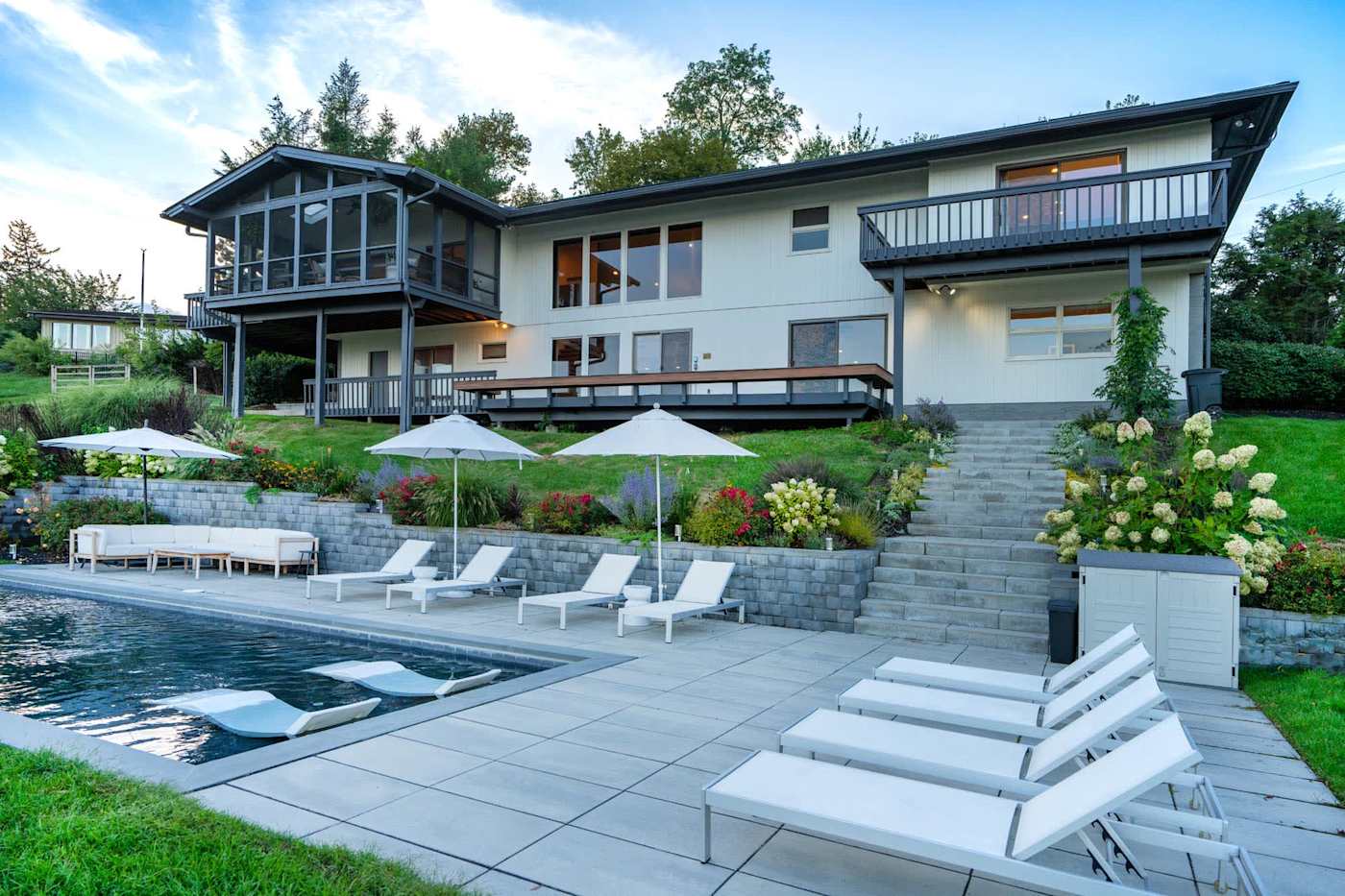 Hudson House: Pool patio with chaises and stone steps up to the house