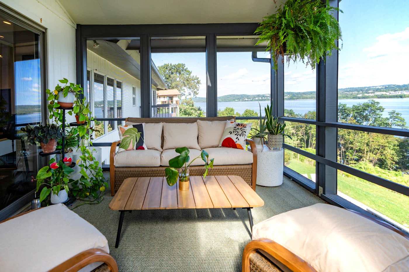 Hudson House: Screened porch sofa and coffee table with river views