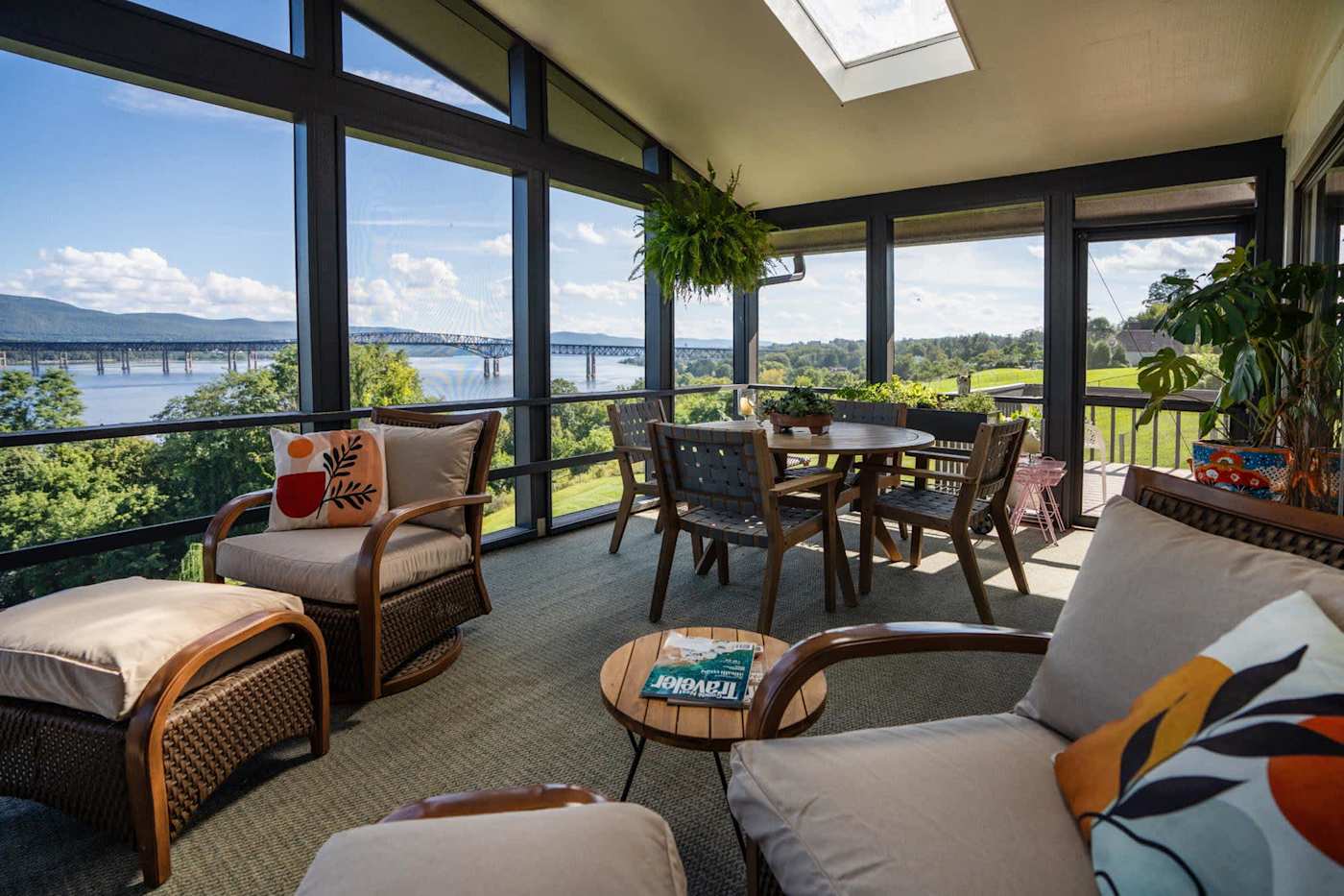 Hudson House: Screened porch lounge chairs with the river and bridge in view
