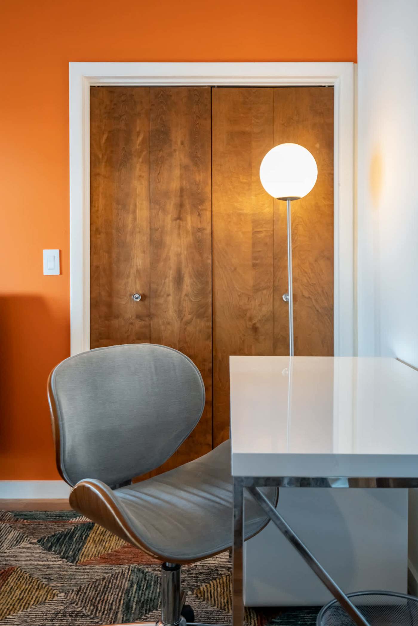 Hudson House: Desk and chair in the orange-walled bedroom