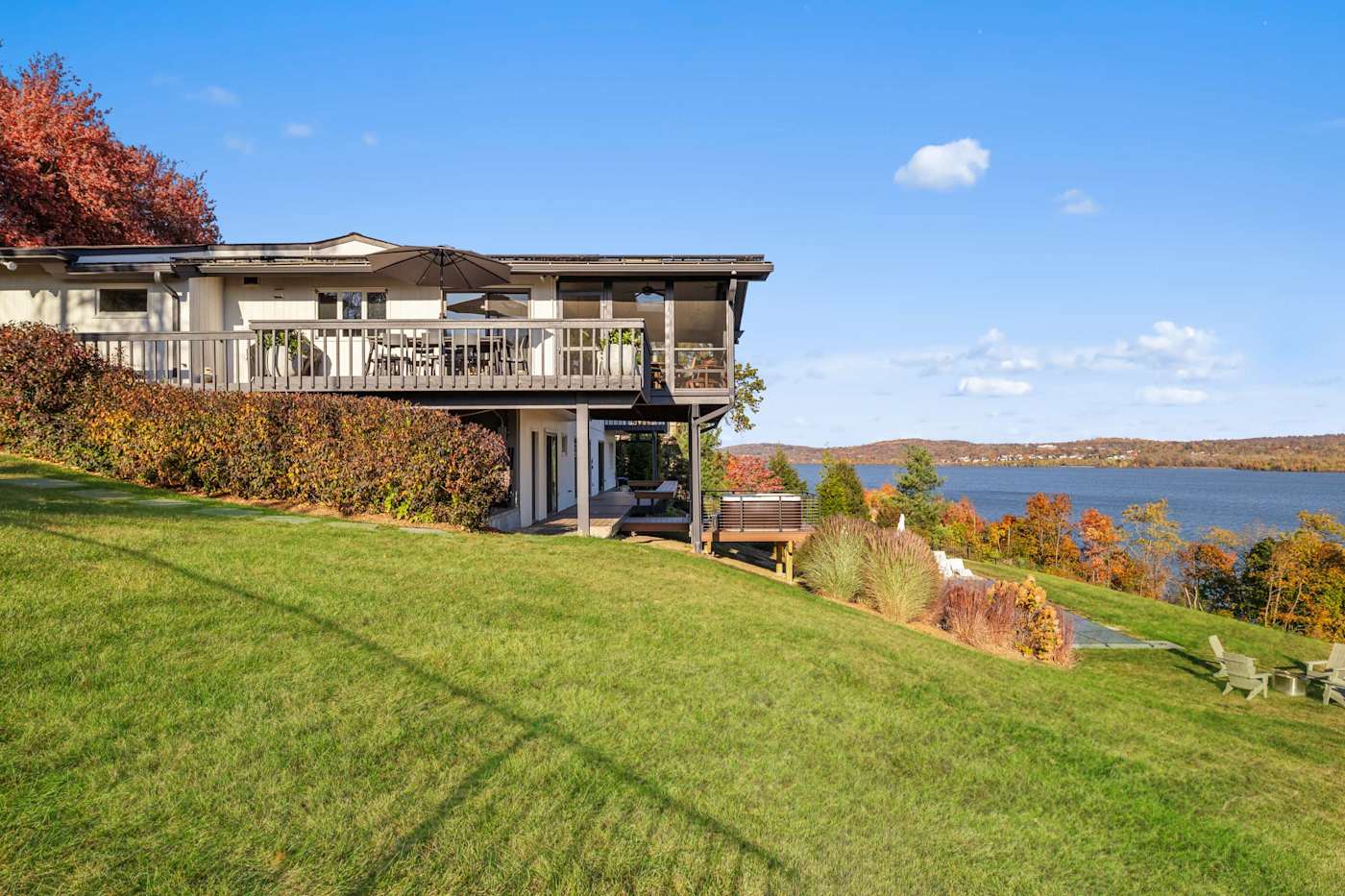 Hudson House: Side of the house and deck above the lawn sloping to the river