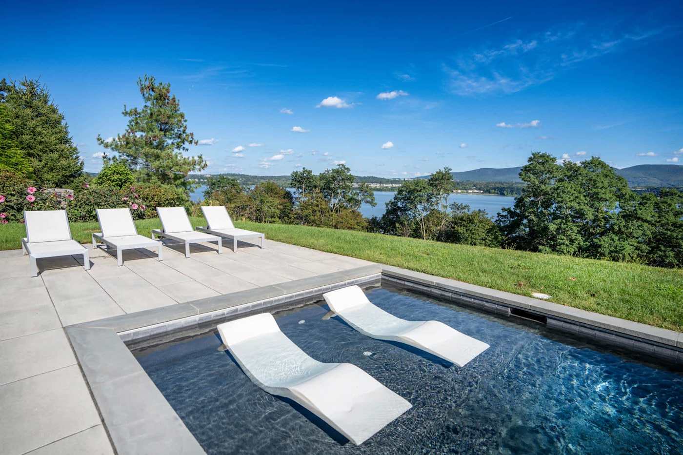 Hudson House: Heated pool with in-water loungers and chaises on the patio