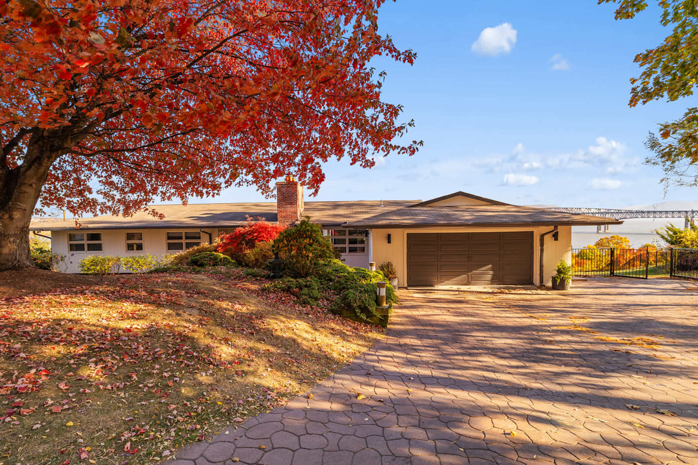 Hudson House: Front of the house with two-car garage under fall foliage