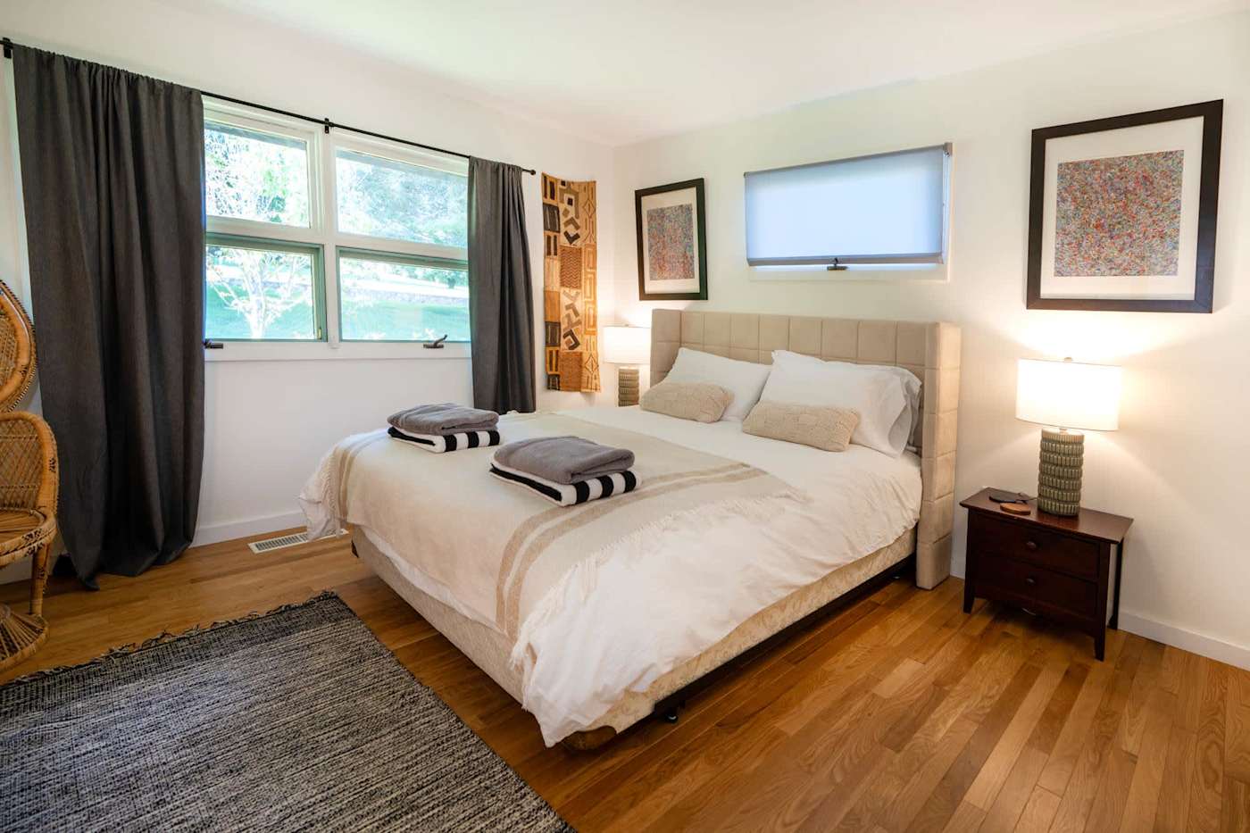 Hudson House: Bright bedroom with tufted headboard, two nightstands and garden windows
