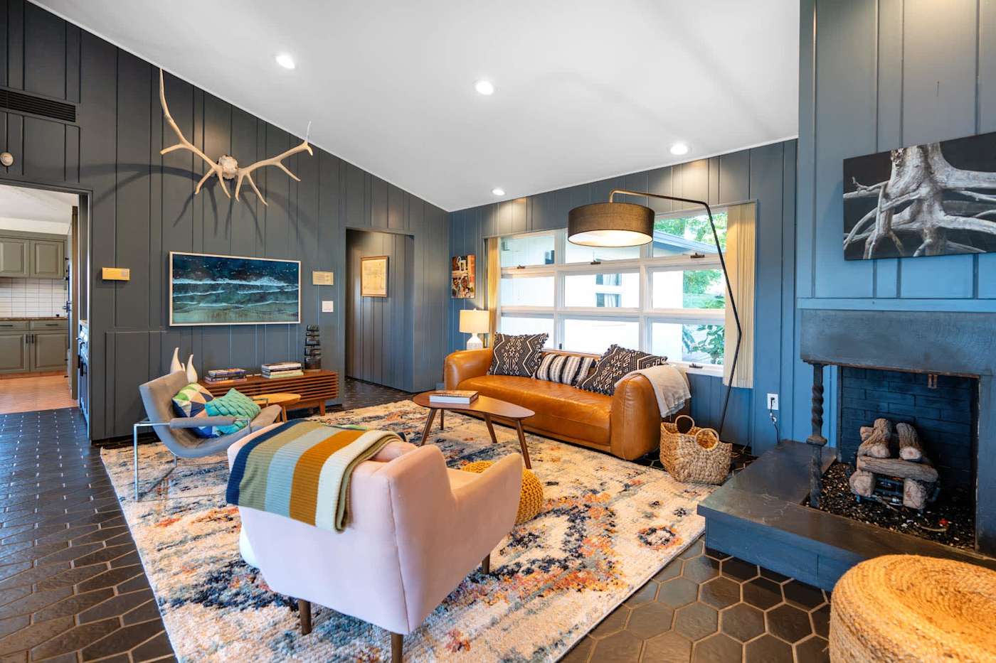 Hudson House: Den with fireplace, leather sofa and blue-gray paneled walls