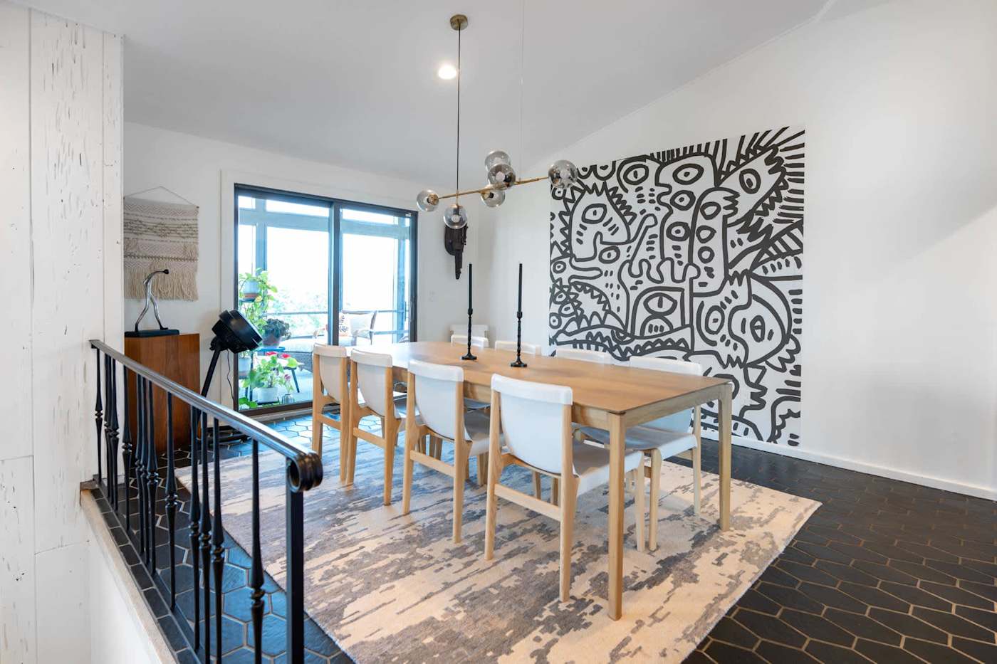 Hudson House: Dining room with table for eight and a graphic mural wall