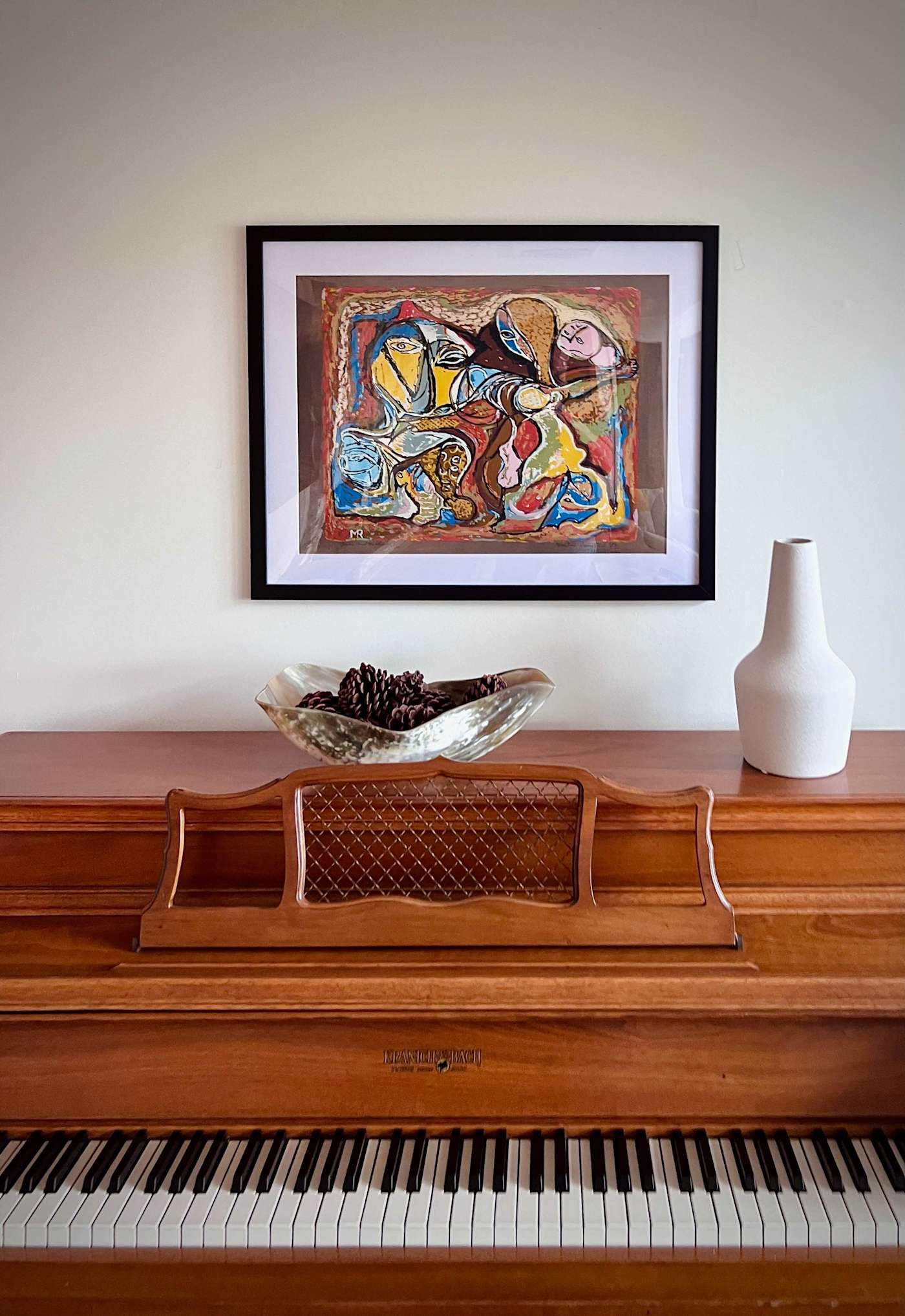Hudson House: Upright piano with framed artwork