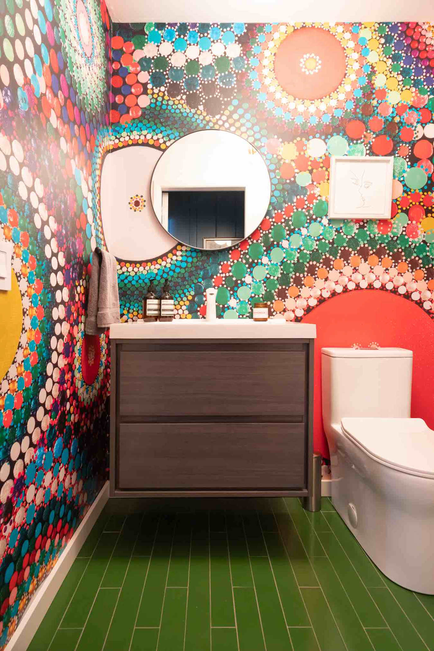 Hudson House: Powder room with bold patterned wallpaper and green tile floor