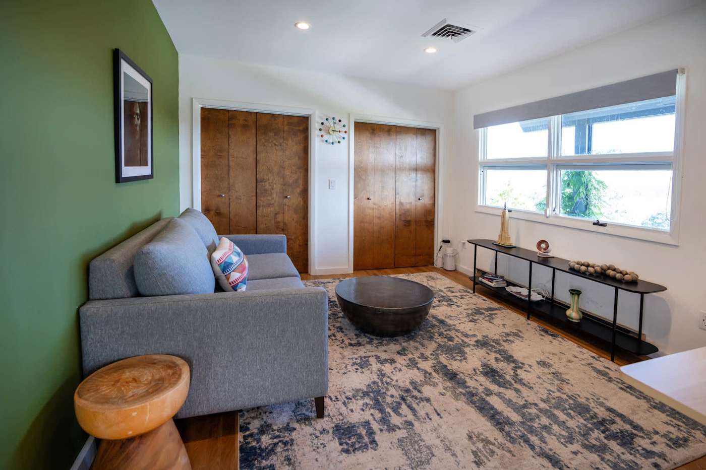 Hudson House: Room with sofa, green accent wall and closets
