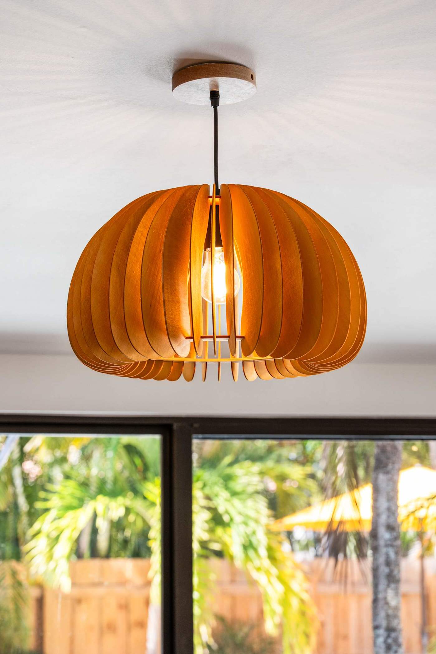 Mangrove Manor: Wood slat pendant light over the dining table