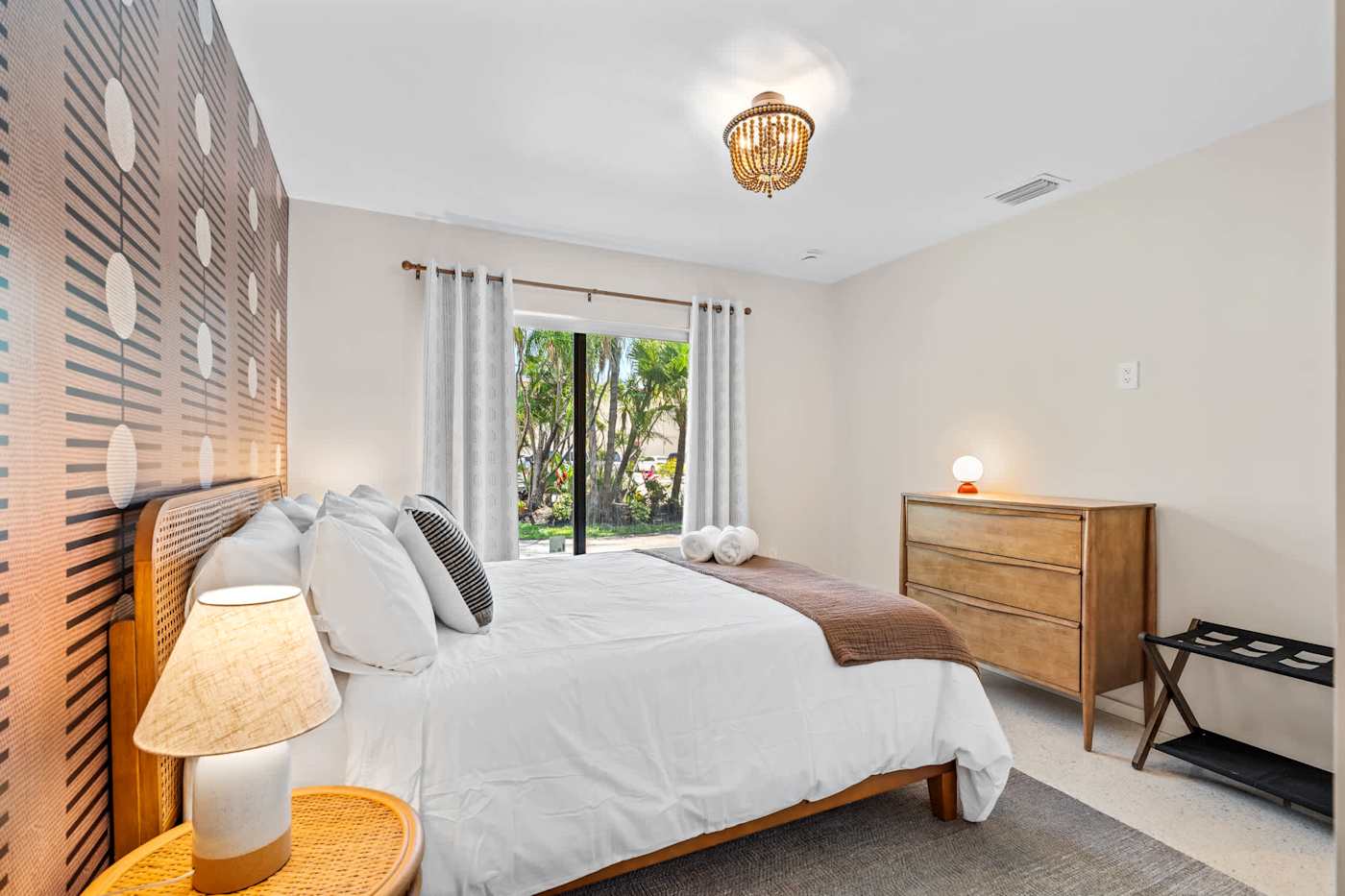 Mangrove Manor: King bedroom with wood dresser and garden view
