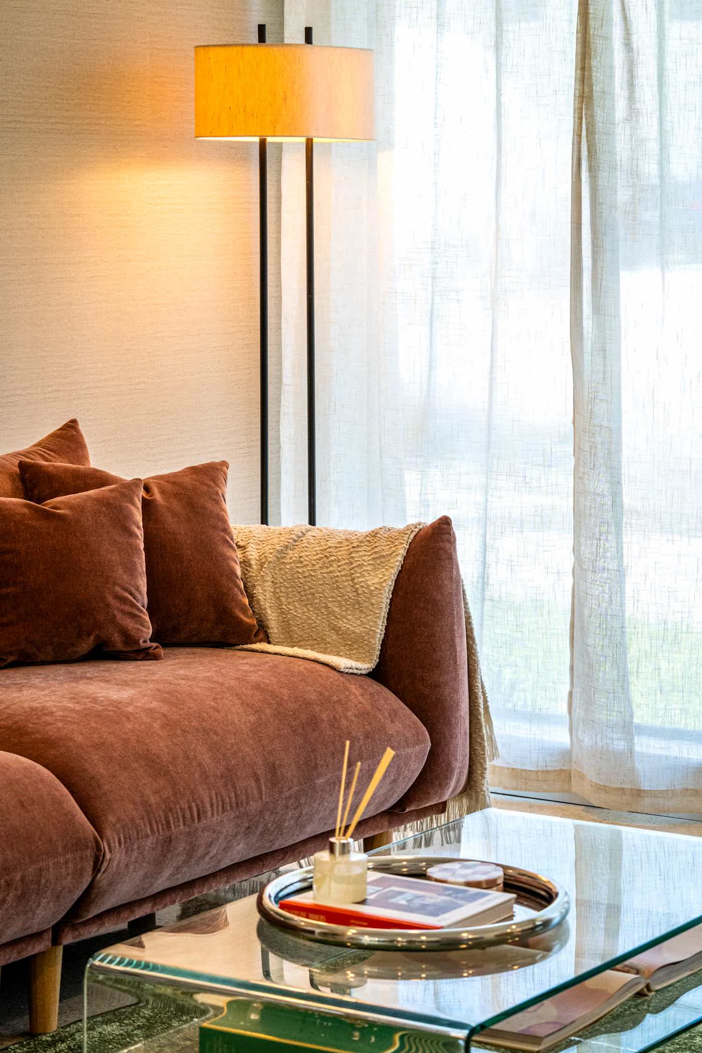 Mangrove Manor: Rust velvet sofa in the second living room, with sheer curtains to the garden