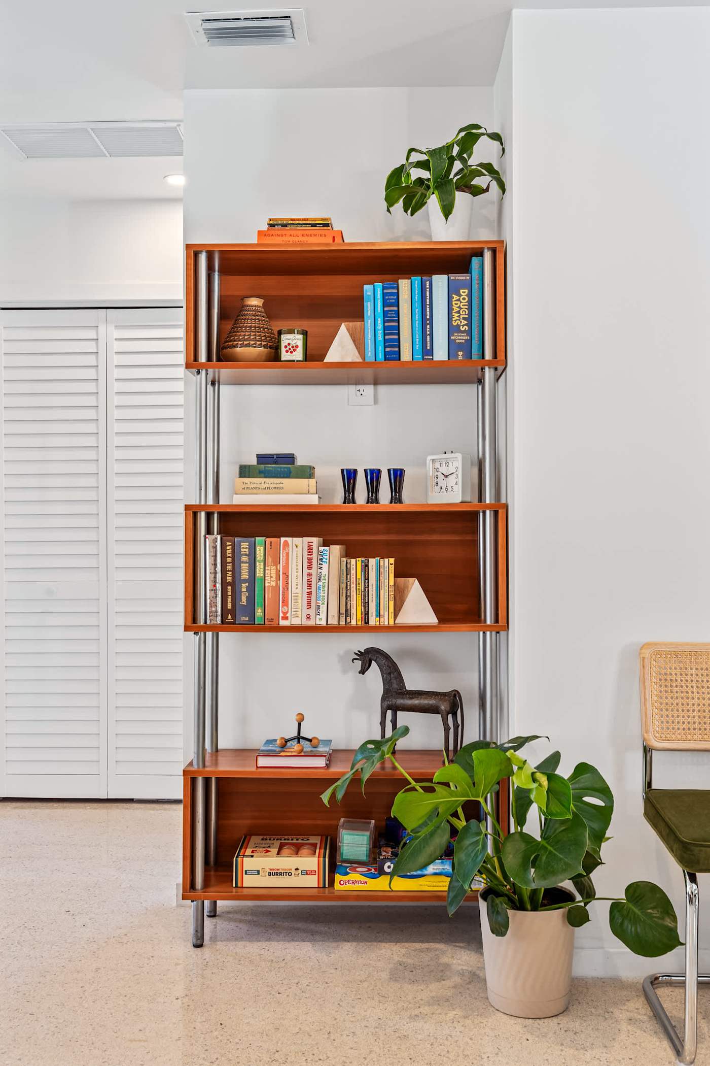 Mangrove Manor: Shelving stocked with books, games and vinyl