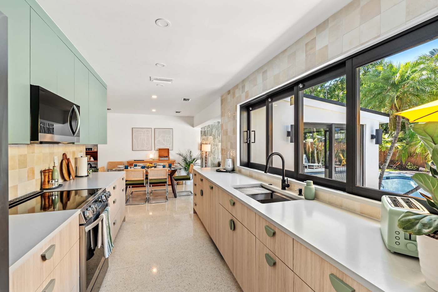 Mangrove Manor: Galley kitchen opening through to the dining area and living room