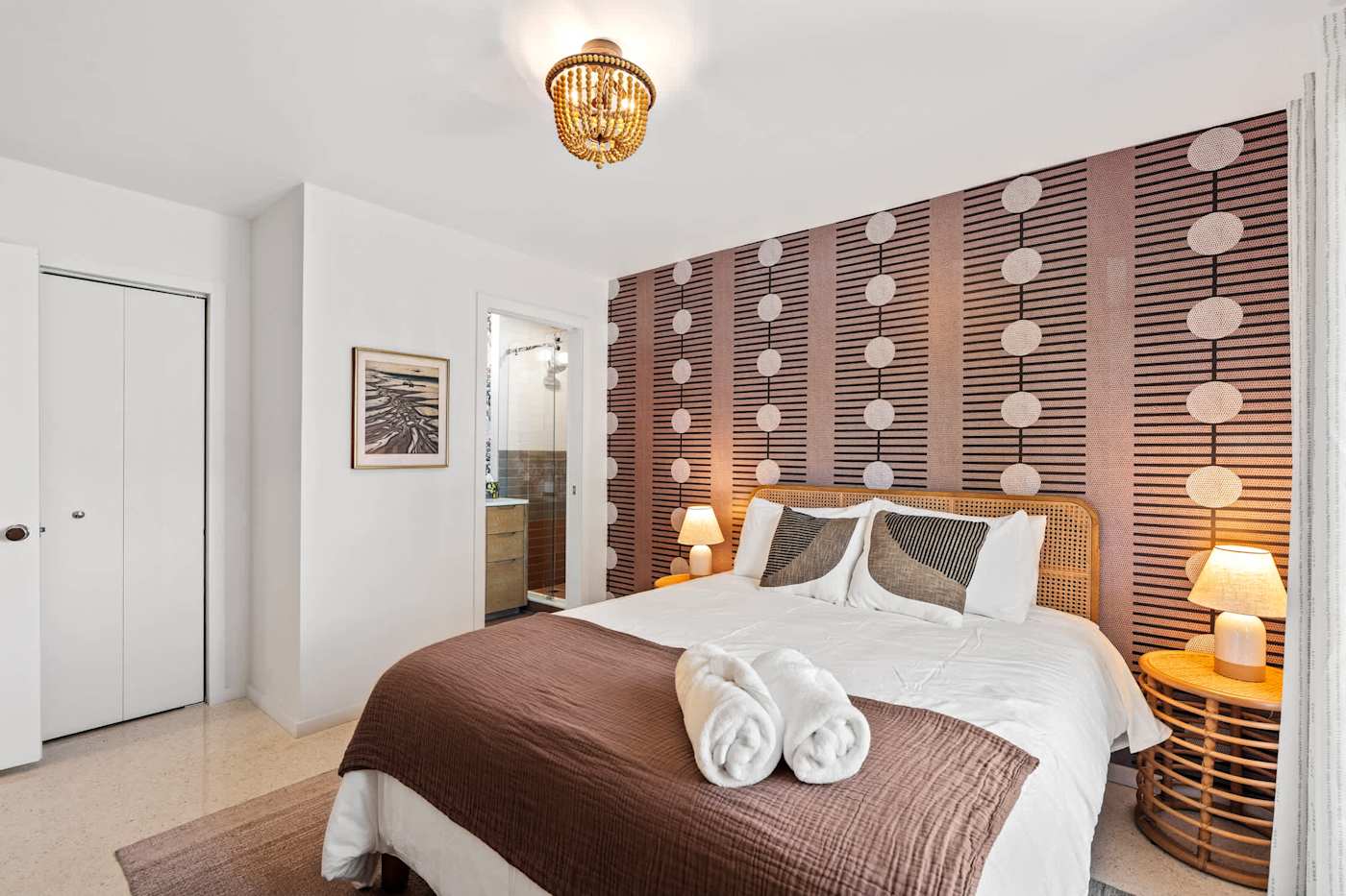 Mangrove Manor: Bedroom with fresh towels laid out and a patterned feature wall