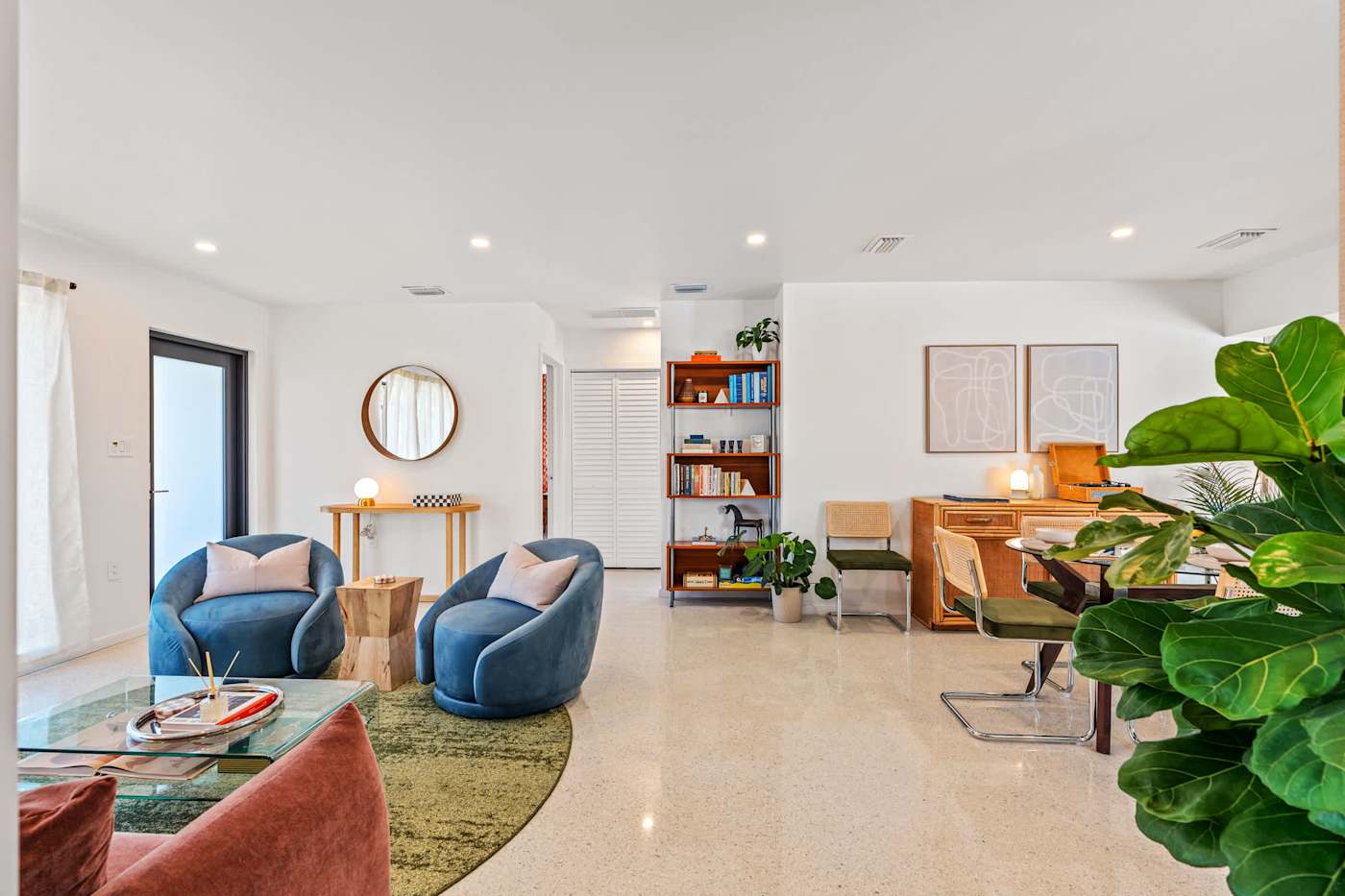 Mangrove Manor: Open living space with armchairs, a desk and plants throughout