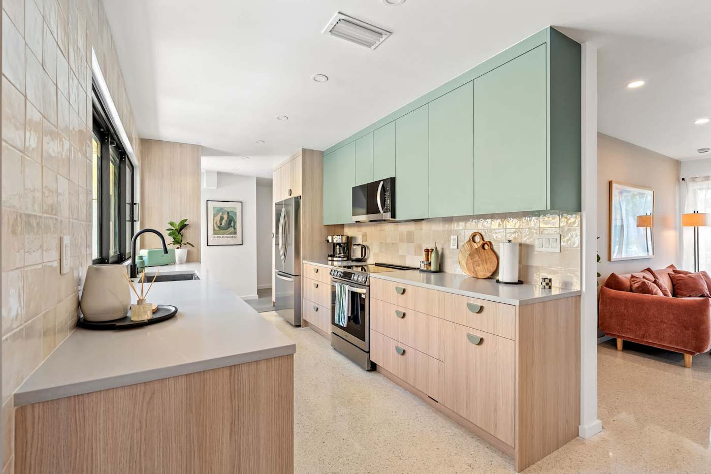 Mangrove Manor: Sage green kitchen with full size appliances, seen from the dining room