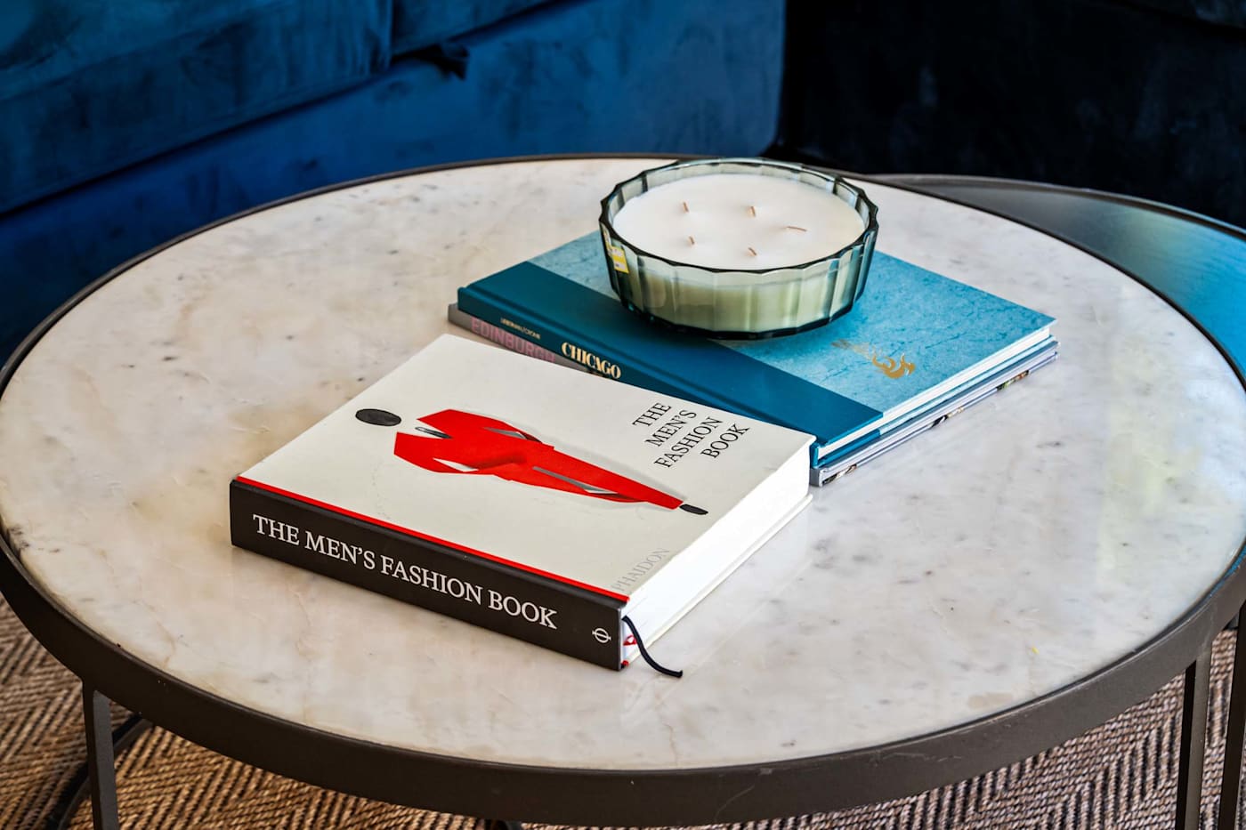 Mangrove Manor: Coffee table books and a candle on the marble side table