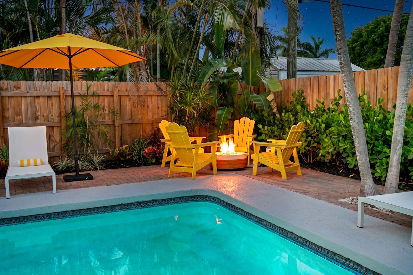 Mangrove Manor: Heated pool with the fire pit lit at dusk