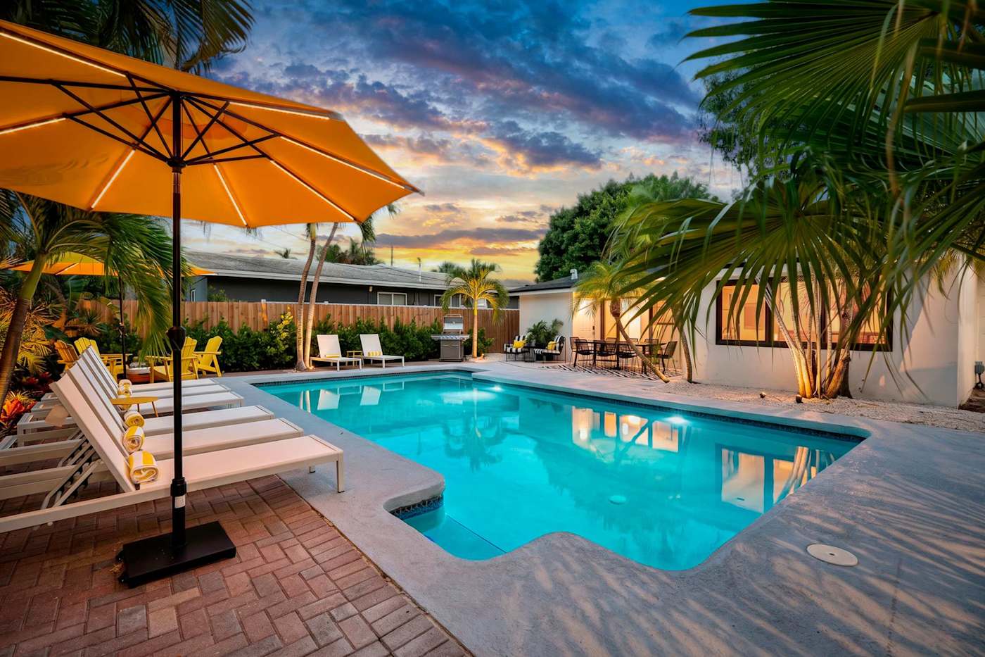 Mangrove Manor: Heated pool and sun loungers at sunset