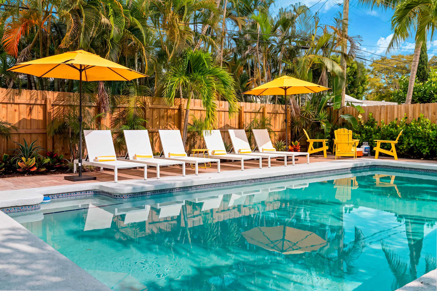 Mangrove Manor: Heated pool with sun loungers and shade umbrellas