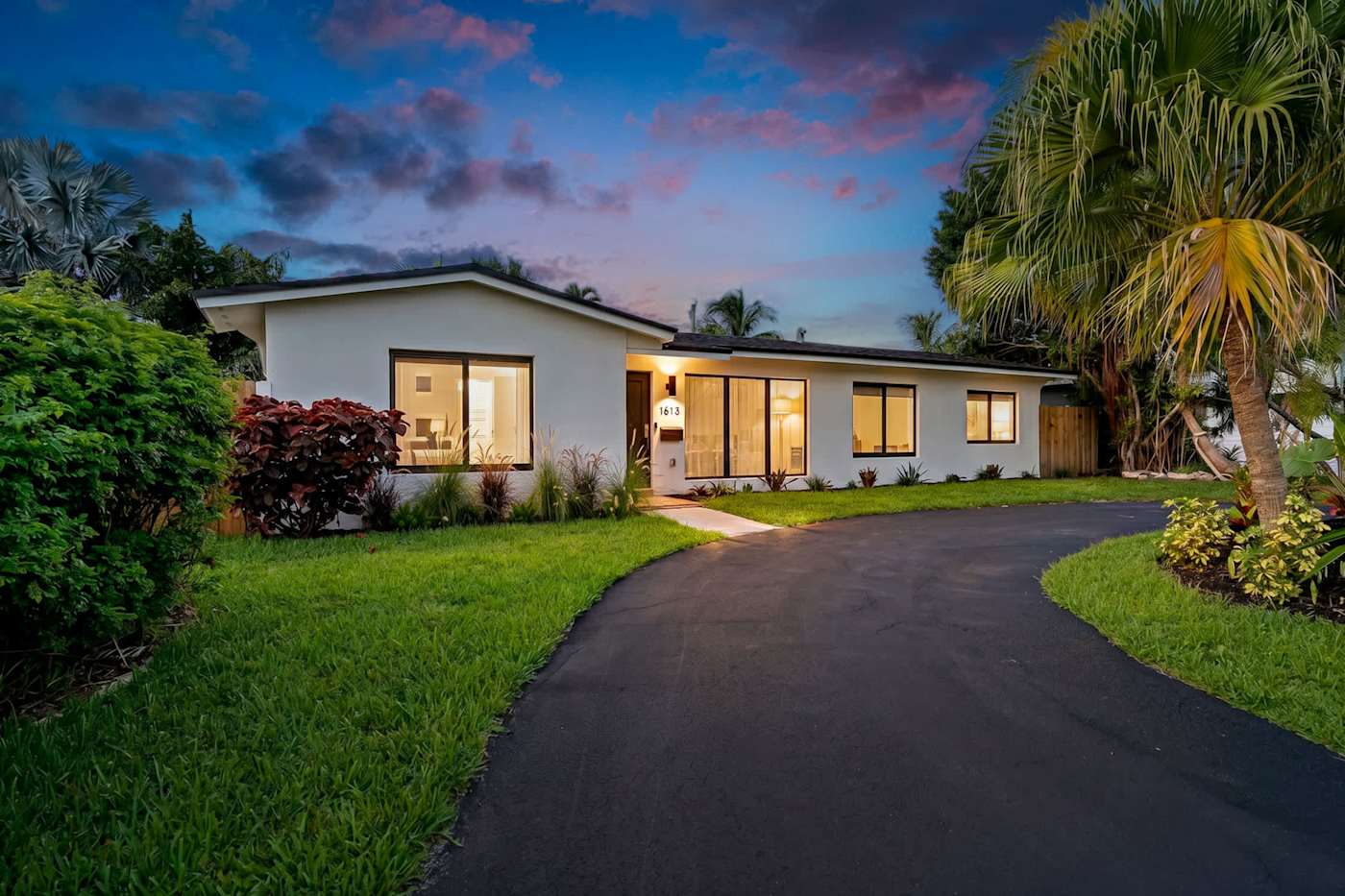 Mangrove Manor: The house at dusk, seen from the driveway