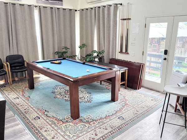 【Shared Great Room】Blue-felt pool table by the windows — rematch before dinner