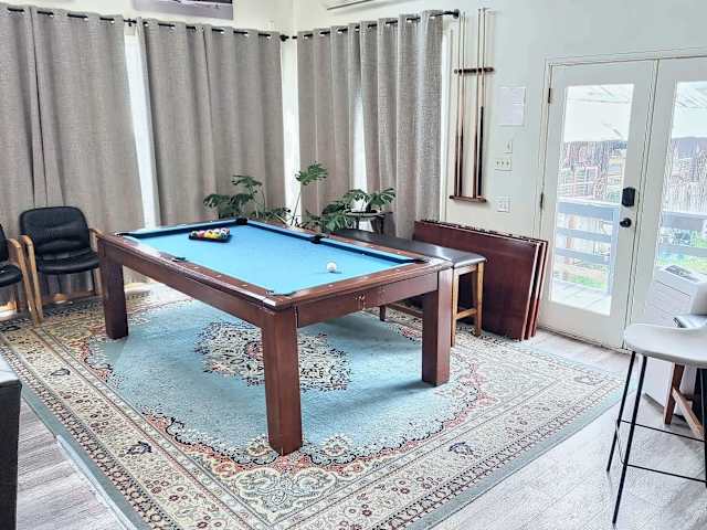 【Living Room】 Pool table converts for group dining — 65" TV + stereo behind you