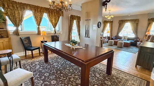 【Billiard Room】Full-size table under the chandelier — the nightly rematch