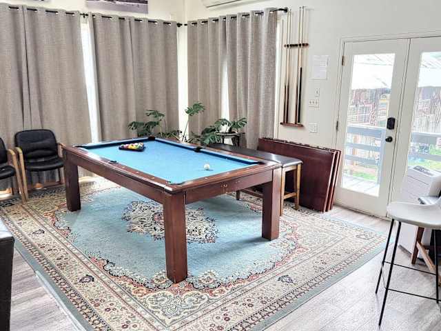 【Living Room】 Pool table converts for group dining — 65" TV + stereo behind you