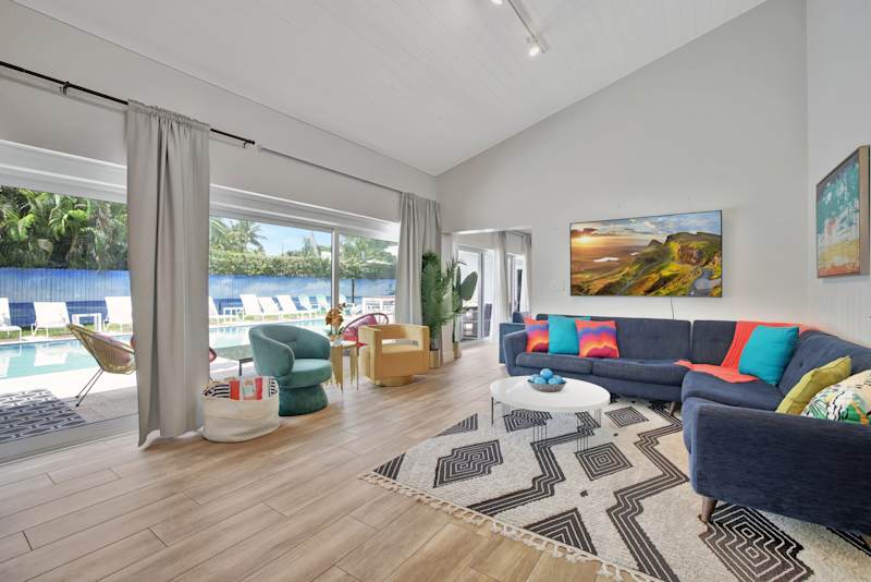 6 Bed Beach House: Open plan living with two seating areas and doors to the pool