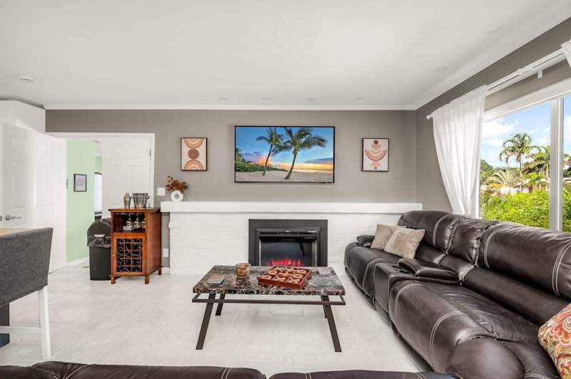 The Fairway: Living room with leather sectional, fireplace and smart TV
