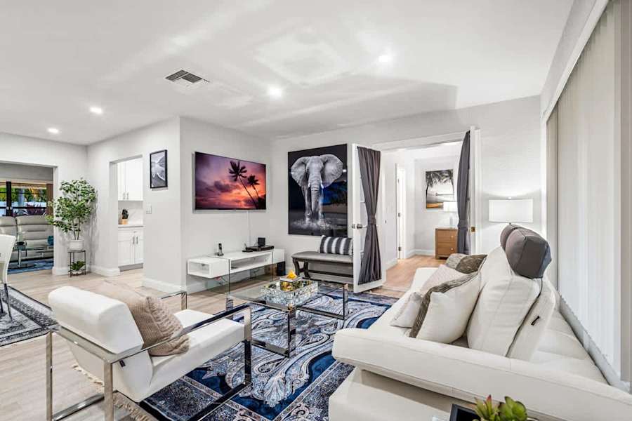 Gardens By The Sea: Living room with two sofas and a smart TV, looking through to the bedrooms