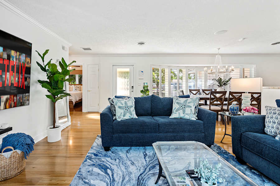 Cypress Cove: The living room opens up to the dining area behind it