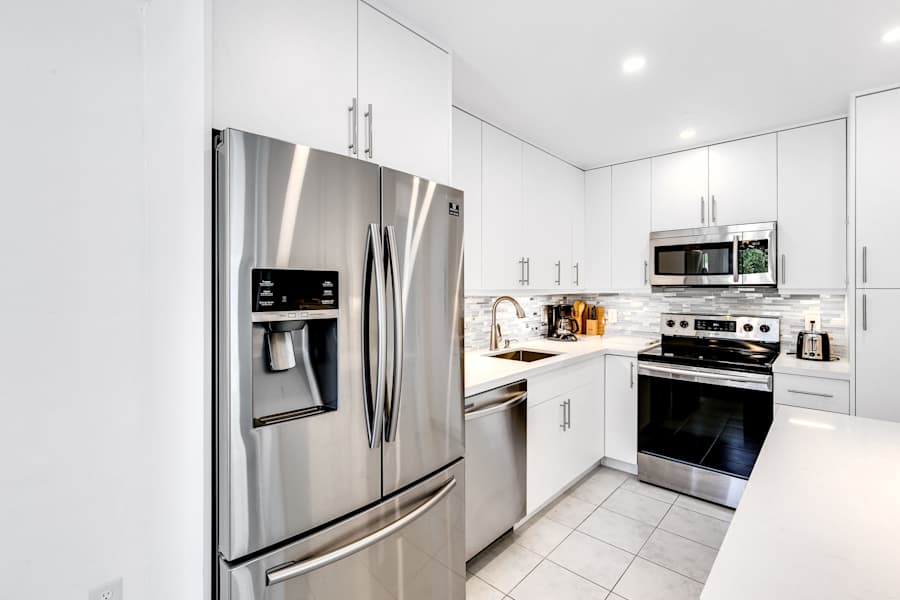 Pompano Bungalow: Closed shelves in the kitchen give a clean, uncluttered look