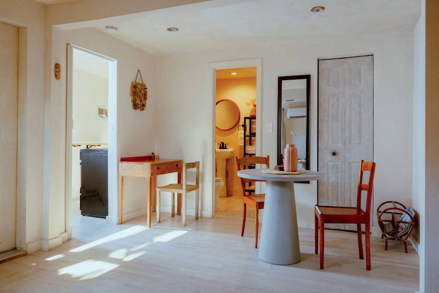 Sombra Cottage: Living room that shows where the bathroom is plus the kitchenette