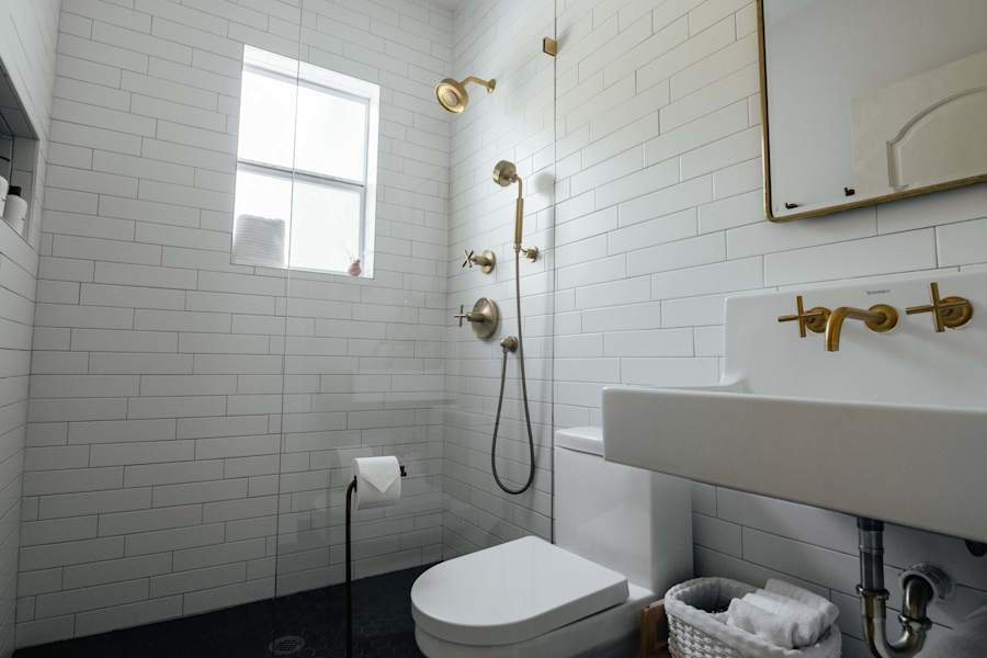 Sol y Sombra: Full bathroom with gold finishes throughout featuring a shower head and hose complete with shampoo, conditioner and body wash for your use
