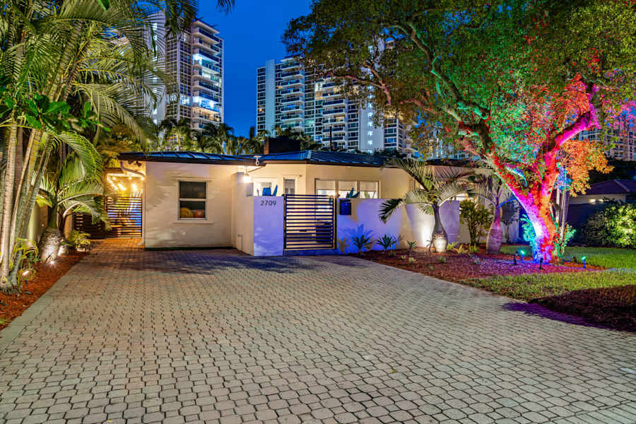 Beach Pop House: The house at dusk with the garden lit