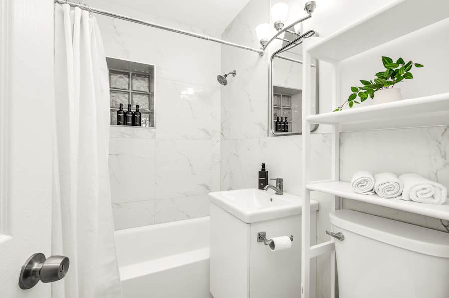 The Fairway: Bathroom with bath, shower over, vanity and shelved towels