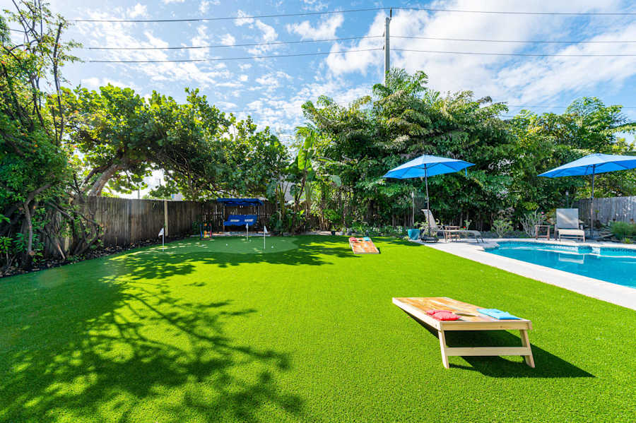 The Fairway: Lawn with cornhole, the putting green and pool beyond