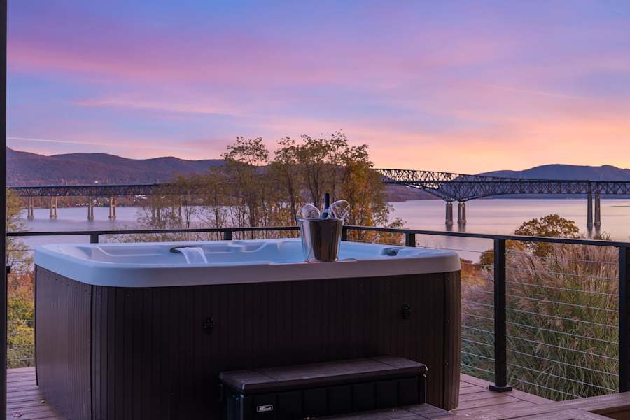 Hudson House: Hot tub on the deck at sunset overlooking the river and bridge